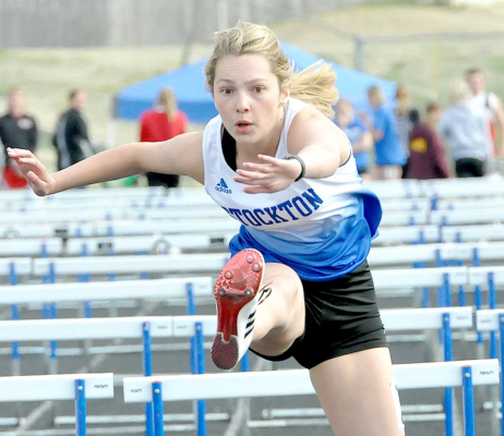 FRESHMAN BRECKYN WILLIAMS glides over the last hurdle en route to her first-place finish in the 100 Meter Hurdles at the Stockton Invitational track meet.