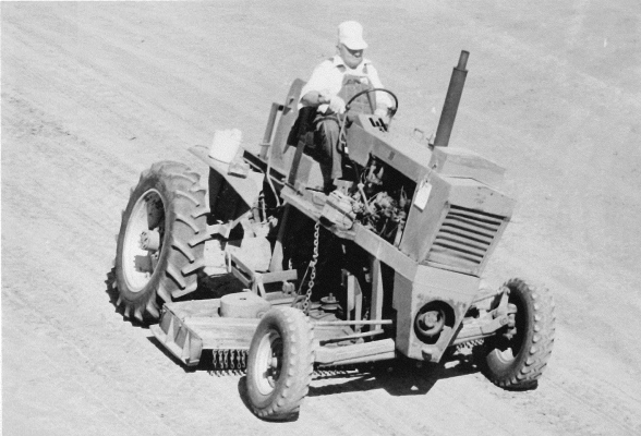 AT THE END OF SEPTEMBER 1989, the 12th annual Solomon Valley Antique Engine and Machinery Association Threshing Bee and Craft Fair showcased an impressive collection of antique tractors, cars, and farm equipment. The event took place at the Rooks County Fairgrounds and featured 388 exhibits from 153 exhibitors. The parade included 130 entrants, with Bob Atkisson featured in this photo driving Mary Lou Atkisson’s tractor.