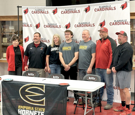 PLAINVILLE HIGH SCHOOL senior Tucker Rudman signed his letter of intent last Friday to continue his track and field career with the Hornets at Emporia State University. Rudman plans to compete in the shot put and discus, with the possibility of also participating in the hammer and weight throws. Joining him for the signing were his parents and coaches. Pictured from left are Norma Finnesy, Alex McMillian, mother Gina Rudman, Tucker, father Troy Rudman, TJ Staab and Ryan Becker.