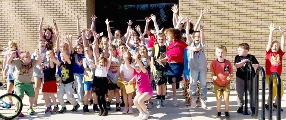 IMM KIDS AND ADULTS JUMPING FOR JOY during National Library Week.