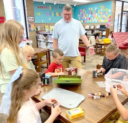 Chris Hansen of Palmer Hargrave volunteering at Game Club at the Plainville Memorial Library.