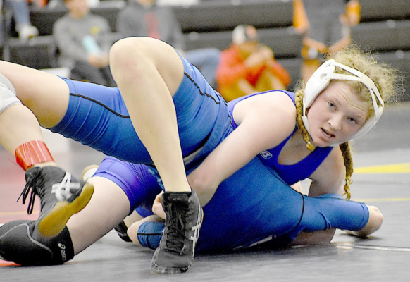 STOCKTON TIGER FRESHMAN ASHLYN HAHN is determined to pin her opponent at the wrestling tournament held in Goodland recently. (Photo courtesy of SHS Yearbook)