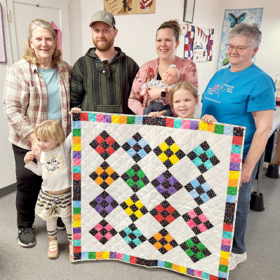 THE CROSSROADS QUILT GUILD presented the 2024 New Year’s Baby with a beautiful quilt. Sweet baby Rebekah VanSkike, her parents Luke and Holly, and big sisters Katie and McKenzie attended the March guild meeting to receive the colorful quilt, which was lovingly made by members Betty Bedore and Elaine Hrabe.