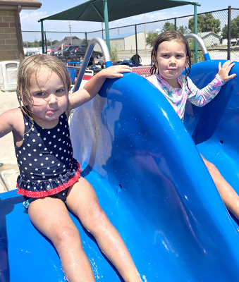 THE GREAT-GRANDDAUGHTERS OF GLEN BUSS (Stockton), Kitt and Della Pabst of Logan were having some fun at the Stockton Swimming Pool.