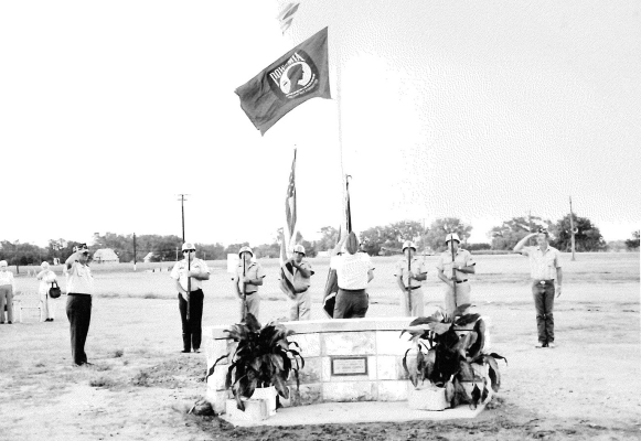 PRIORTOTHE MICKEY GILLEY CONCERT on Thursday night of the 1989 Rooks County Free Fair, a flag pole and monument were dedicated to the late J. O. 'Jimmie' Copper for the extra hours he donated to the success of the Fair for many years. Shown are members of the VFW Post #8873 raising the United States and MIA flags.