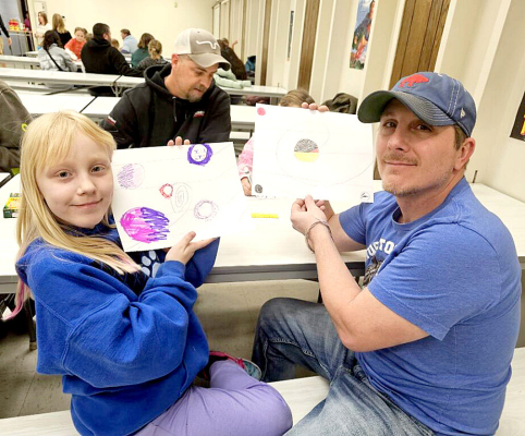 SHOWING OFF THEIR WORKS of art at the SGS Family Engagement night are Kitlynn and Ian Snyder.