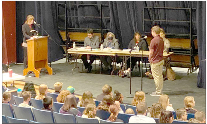 PLAINVILLE JUNIOR HIGH EIGHTH GRADER PEYTON KROB is given his opportunity to spell a word at the State Spelling Bee in Wichita as the other contestants look on.