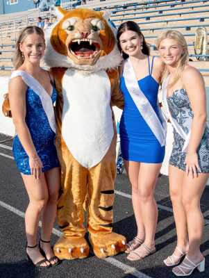 HOMECOMING QUEEN candidates Ava Dix, Aubrey Kesler, and Ashlyn Hahn pose with the Tiger mascot prior to the Homecoming festivities last Friday.