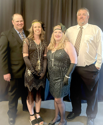 JUNIOR CLASS SPONSORS Jen Kesler (left) and Amber Muir, along with their husbands, Zach and Andy, enjoyed dressing up for Prom this year, which had the theme, “The Great Gatsby.”