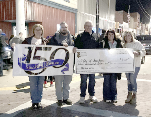 THE CITY OF STOCKTON was presented with a $3,000.00 grant donation from the Heartland Community Foundation during the town’s Olde Tyme Christmas and 150th birthday celebration on Friday, November 25th for the new Christmas Lights project. Pictured are (from left): mayor Reesa Brown, commissioners Adam Bryant, Bob Becker, Jesica Kerr and assistant city clerk Kayla Hilbrink. (Courtesy Photo)