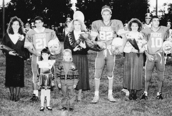 PRIOR TO THE 1991 STOCKTON/NORTON HOMECOMING FOOTBALL GAME, the SHS Homecoming Queen and King were crowned. Pictured are (from left) Nicki Travlos, Craig Lavid, Queen Sherry Kriley, King Tim Bouchey, Tasha Riffel, and Charlie McDonald. Amber Kollman and Drew Waller were the crown bearers.