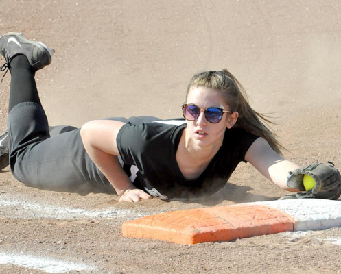 ASHLYNN STAMPER of Plainville snags the softball and tags first base during the RoCo girls’ game against Ellis on April 1.
