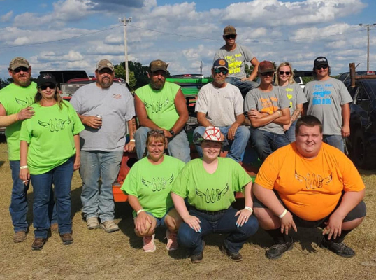 HONORING BRADEN “BUBBA” HIGDON one last time at the Rooks County Fair’s Demolition Derby were (front row): Misty Higdon, Rhianna Higdon, Wes Higdon; (second row) Clay Boller, Jana Diers, Jeremy Pride, Brad Higdon, Darrin Brown, Blake Brown, Sage Klein-Richards, Chase Morlean; and (on car) Dalton Brown.