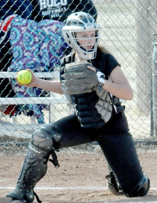 ROCO CATCHER ASHLYNN STAMPER considers a throw to second base during recent softball action in Plainville between the RoCo girls and Ness City.
