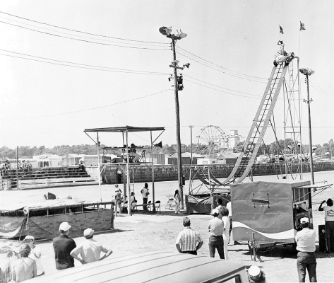 AS WE APPROACH THE 146TH ROOKS COUNTY FREE FAIR, this vintage photo showcases the grandstand act of the Swenson Thrillcade, which provided entertainment at the Fair in 1963, 1964, and 1965. The world-famous daredevils captivated audiences with their thrilling, supercharged stunts.