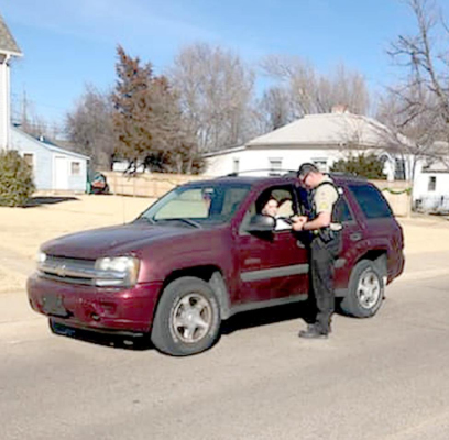 A GREAT BEND POLICE DEPARTMENT officer speaks with a driver during the SAFE Enforcement Campaign, held between Feb. 22 and March 5 near high schools across Kansas to encourage teens to drive safely.