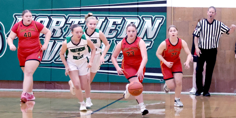 AFTER GRABBINGTHE OUTLET PASS, Logan-Palco’s Graci Bliss heads to the Trojan end of the court with Breyer Delimont and Shiloh Kuhn trailing behind her in the game against Northern Valley.