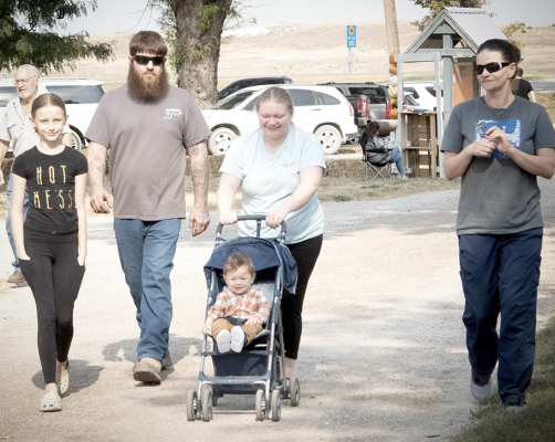 ERIC AND JEN PFEIFER and family stroll through the Pumpkin Patch on Saturday. Daughter Reagan (far left) of Arizona had fun joining the Pfeifers’ grandson, Charlee, for his first Pumpkin Patch experience, as did his mom, Hailey Baxter.