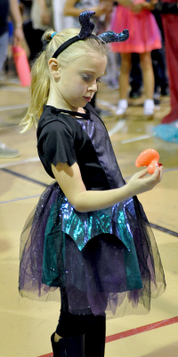 EMERY PETERSON checks the bottom of the duck to see what she won during the annual Goblin's Glory held last Saturday.