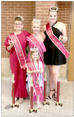 ISABELLA BURK, Wendy Adams, Savy Gray and Skilynn Birdsall (front), are pictured with many of their awards, titles and trophies they won at the state and national Our Diamond Miss competition held in Chickasha, Oklahoma on July 17th through July 23rd.