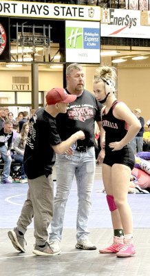 Coaches Klein &amp; Becker give instruction to Plainville’s Hayden Staab at the State Wrestling Tournament.