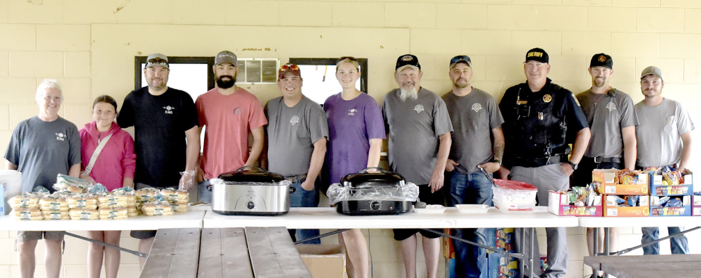 THE ROOKS COUNTY EMS AND STOCKTON FIRE DEPARTMENT served lunch at the Swing Into Summer Car Show held at the Lower City Park on Saturday, June 14. Those helping were from left: Angie Lowe, Haddie Carpenter, Michael Carpenter, Trent Collins, Brian Cockrell, Megan Wise, Mack Palmer, Dan Schroeder, Ray Niblock, Derry Dibble and Riley Wise. The Car Show is sponsored by The Stockton Rodders, Rooks County EMS, City of Stockton, and the Stockton Fire Department.