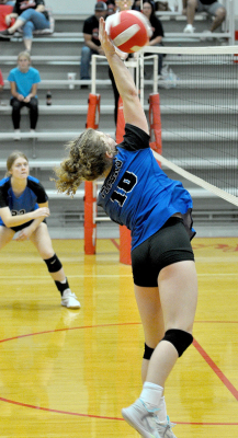 ASHLYN HAHN spikes the ball against Osborne at the Hill City Triangular last Tuesday. Also pictured is Liz Busonic.