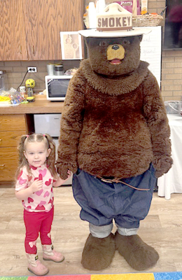 AVERY RAMSEY pictured with Smokey the Bear (Sierra Reed)