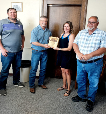 SADIE LOOK was presented with her ten-year plaque for serving Rooks County as the Rooks County Highway Department Office Manager at the May 28th Rooks County Commission meeting. Pictured are (from left) commissioner Jake Prockish, commissioner John Ruder, Sadie Look, and commissioner Tim Berland. (Not pictured is Terry Pulec who also received his ten-year plaque.)