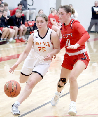 DRIVING TO THE BASKET, Logan-Palco freshman Shiloh Kuhn tries to beat the Ringneck defender down the court. (Photo courtesy of Logan High School Yearbook)