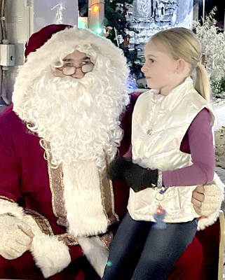 RYLIE COUSE shares her Christmas wishes with Santa during his annual visit to Stockton’s Olde Tyme Christmas last Friday night.
