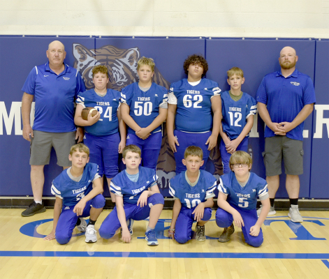 THE 2024 SJH TIGER FOOTBALL TEAM members are front row, from left: Lane Muir, Hudson Kriley, Kyler Hrabe, and Brody Odle; and back row, from left: Ray Niblock (head coach), Garrison Mongeau, Hudson Muir, Sean Green, Cobi Earl, and David Ghumm (assistant coach).