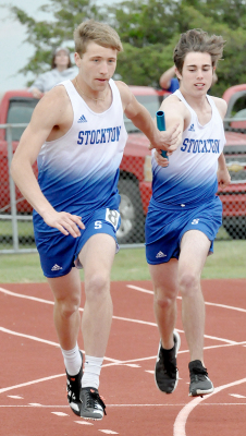 GARRYWAYNE MOORE hands the baton off to Austin Mitchell, left, in the 4x100 Meter Relay at the MCL Track Meet in Hill City.