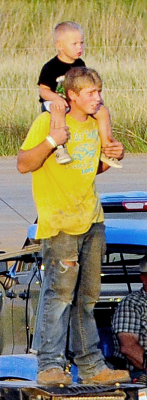 COUSINS SKYLAR KING and his little buddy, Cayson Earl, enjoy the sights and sounds of the Demolition Derby during the Rooks County Free Fair.