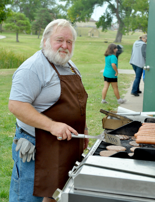 MIKE ROGERS got lots of practice flipping patties and tubes at the Pumpkin Patch on Saturday at the Lions Club food stand.